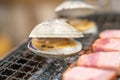 Fresh shell and pork are grilled on mini strove, in local Japanese restaurant Royalty Free Stock Photo