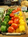 Fresh shiny red yellow and green shiny peppers in a basket on display on a market stall Royalty Free Stock Photo