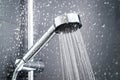 Fresh shower behind wet glass window with water drops splashing.