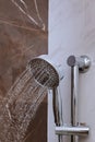 Fresh shower with water drops splashing. Water running from shower head and faucet in modern bathroom Royalty Free Stock Photo