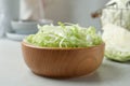 Fresh shredded cabbage on light table, closeup Royalty Free Stock Photo