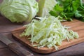 Fresh shredded cabbage on wooden cutting board Royalty Free Stock Photo