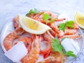 Fresh shrimp, ice, lemon on a gray concrete background Royalty Free Stock Photo