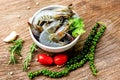 Fresh shrimp on white bowl and wooden background with ingredients herb and spices for cooking seafood - raw shrimps prawns Royalty Free Stock Photo