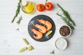 Fresh shrimps with lime and rosemary on white wooden table