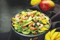 Fresh Shrimps, Mango and Avocado Salad with Walnut, Spinach and Arugula. Top view, gray table Royalty Free Stock Photo