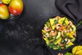 Fresh Shrimps, Mango and Avocado Salad with Walnut, Spinach and Arugula. Top view, gray table Royalty Free Stock Photo