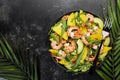 Fresh Shrimps, Mango and Avocado Salad with Walnut, Spinach and Arugula. Top view, gray table Royalty Free Stock Photo