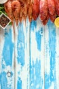 Fresh shrimps and red mullet fish on blue wooden background Royalty Free Stock Photo