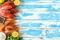 Fresh shrimps and red mullet fish on blue wooden background Royalty Free Stock Photo