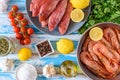 Fresh shrimps and red mullet fish on blue wooden background Royalty Free Stock Photo