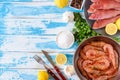Fresh shrimps and red mullet fish on blue wooden background Royalty Free Stock Photo