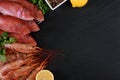 Fresh shrimps and red mullet fish on dark stone background Royalty Free Stock Photo
