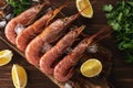 Fresh shrimps on wooden background with lemon slice. Seafood background