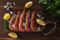 Fresh shrimps on wooden background with lemon slice. Seafood background