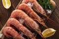 Fresh shrimps on wooden background with lemon slice. Seafood background