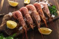 Fresh shrimps on wooden background with lemon slice. Seafood background