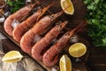 Fresh shrimps on wooden background with lemon slice. Seafood background