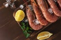 Fresh shrimps on wooden background with lemon slice. Seafood background