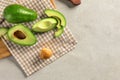 Fresh sliced avocados on table, top view