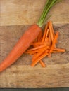 Fresh and sliced carrots on wooden background. Royalty Free Stock Photo