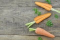 Fresh carrots and double cut on wooden background Royalty Free Stock Photo