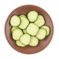 Fresh sliced cucumber in a brown plate. Isolated on white background. Royalty Free Stock Photo