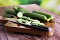 Fresh and sliced cucumbers. Sliced cucumbers on a cutting board. Royalty Free Stock Photo
