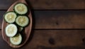 Fresh Sliced Cucumbers on a Wooden Plate, Copy Space