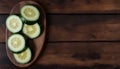 Fresh Sliced Cucumbers on a Wooden Plate, Copy Space