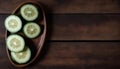 Fresh Sliced Cucumbers on a Wooden Plate, Copy Space