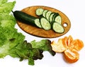 Fresh sliced green cucumber on a wooden board. Coooking salad. Diet food Royalty Free Stock Photo