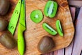 Fresh sliced kiwi fruit and knife on wooden board Royalty Free Stock Photo