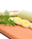 Fresh sliced leeks and dill on a wooden board Royalty Free Stock Photo