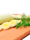 Fresh sliced leeks and dill on a wooden board Royalty Free Stock Photo