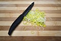 Fresh sliced leeks on a wooden board. Royalty Free Stock Photo