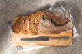 Fresh sliced loaf of rye bread on the wooden cutting board background Royalty Free Stock Photo