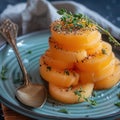 Fresh Sliced Melon with Herbs and Pepper on Blue Plate in Rustic Setting Royalty Free Stock Photo