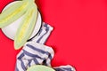 Fresh sliced melon on a plate on bright red background Royalty Free Stock Photo