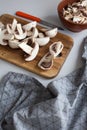 Fresh sliced mushrooms at wooden cutting board. Chopping food ingredients Royalty Free Stock Photo