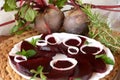 Fresh sliced organic beetroot with onion decorated on a white plate Royalty Free Stock Photo