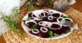 Fresh sliced organic beetroot with onion decorated on a white plate Royalty Free Stock Photo