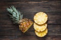 Fresh sliced pineapple on a wood table. Top view