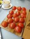 fresh sliced tomatoes on the wooden plate with pistachios Royalty Free Stock Photo