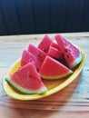 Fresh sliced watermelon on a yellow plate on the table Royalty Free Stock Photo