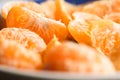 fresh slices of peeled tangerine on a wooden table, close-up, background Royalty Free Stock Photo