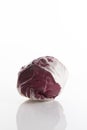 Fresh and small red cabbage on a white surface