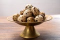Fresh small spotted partridge eggs on bronze plate Royalty Free Stock Photo