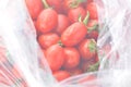 Fresh small tomatoes in plastic bag, fruit Royalty Free Stock Photo