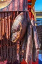 Fresh smoked meats and salami hanging on display in butcher`s shop